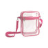 A clear tote bag with a zipper closure and pink trim, featuring an adjustable pink crossbody strap.