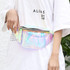 A holographic waist bum bag with a clear front, featuring a zipper and worn around the waist.