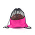 A pink drawstring mesh backpack with a black mesh top, holding a basketball inside. It features a logo.