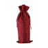 A red wine drawstring bag made of textured fabric, featuring a cinched opening and a flat base.