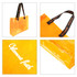 A clear tote bag in bright orange with black handles featuring a logo. The bag has a glossy finish.