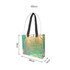 An iridescent clear tote bag with black straps, featuring measurements of 66cm x 38cm x 10cm.