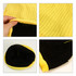 A yellow cable knit beanie featuring a textured ribbed design and a black interior with visible stitching.