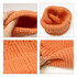 A twisted cable cuffed beanie in a warm orange colour, showcasing its textured design and interior lining.