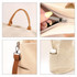 A vintage style canvas bag in beige, featuring a zip closure, side pocket, and brown handles. It includes a logo.