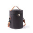 A cylindrical black lunch bag with a zipper closure and a detachable shoulder strap. It has a handle and branding.
