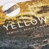 A frosted metal coaster in yellow shades with a textured design and a small inset showcasing its surface detail.