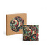 A square ceramic coaster featuring a colourful paisley design, displayed alongside its brown packaging.