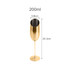 A stainless steel slanted champagne flute in a shiny gold finish, measuring 25.3 cm tall and 5.8 cm wide.