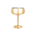 A stainless steel cocktail coupe in a shiny gold finish, featuring a tall stem and round base.