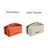 A portable canvas cosmetic bag in orange and cream, featuring zippers and branding on each.