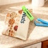 A green clip secures a bag of mixed nuts on a countertop, alongside a blue seal clip.