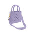 A mini beach bag in lavender with handles and a detachable strap, featuring holes and a simple design.