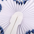 A peach-shaped plastic fan with a white handle and a blue and white pleated design.