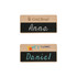 Two wooden chalkboard name badges, featuring a light wood finish with black erasable chalkboard areas.