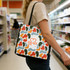 A vibrant tote bag featuring a colorful abstract pattern, being carried by a person in a supermarket aisle.