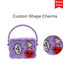 A purple silicone bag featuring custom shape charms, with a handle and multiple holes for design.