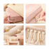 A velvet jewellery box in cream and pink with compartments, showcasing earrings and storage for various accessories.