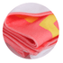A folded sublimated beach towel in pink and yellow with a logo, showcasing a soft, vibrant design.