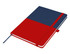 A A5 notebook featuring a red and navy blue design, complete with an elastic closure and a ribbon marker.