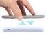 A hand hovering over a white wireless power bank, with an indication of wireless charging in blue above it.