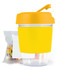 A reusable coffee cup in bright yellow with a matching lid and a clear base, accompanied by a pack of jelly beans.