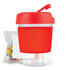 A reusable coffee cup in vibrant red with a lid and a sip spout, accompanied by a small packet of colorful jelly beans.