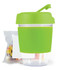 A reusable coffee cup with a bright green silicone sleeve and lid, accompanied by a small bag of colorful jelly beans.