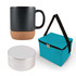 A black coffee mug with a cork base, a silver speaker, and a teal carrying bag.