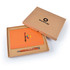 An orange notebook and a silver pen are neatly presented in a cardboard gift box with a logo.