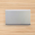 A sleek silver power bank with an 8,000mAh capacity.