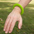 A bright green silicone flyer, designed to be worn as a wrist disc.