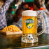 A beer glass with a soccer-themed design features a custom spinner toy on a table with chips in the background.