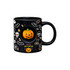 A black ceramic coffee mug featuring Halloween-themed designs and a pumpkin spinner toy in the centre.