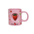 A pink ceramic coffee mug featuring a strawberry design and a custom spinner toy in the centre.