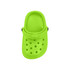 A green classic clog shoe fridge magnet with ventilation holes and a strap. It has a simple design.