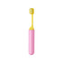 A foldable soft bristle toothbrush in pink and yellow, featuring a compact design for easy storage.