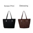 A black tote bag with a shiny finish and a brown suede leather tote bag, both featuring a logo.