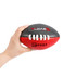 A hand holds a Mini Aussie Rules Ball, featuring black and red colours with white laces and a logo.