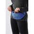 A blue Teton Waist Pack is being worn around the waist, featuring a secure zipper closure.