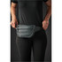 A quilted waist bag in dark grey is being worn around the waist, featuring multiple zippered compartments.