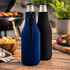 A drink bottle holder in navy and black neoprene, featuring a zip and suitable for standard beverage bottles.