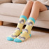 Woven socks featuring a playful pattern of grey and yellow with turquoise cuffs, perfect for casual wear.