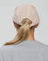 A light beige cap with a five-panel design, featuring an adjustable strap at the back.