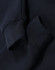 A navy blue fleece sweat with a half zip collar and cuffed sleeves, featuring a logo on the fabric.