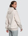 A unisex oversized hoodie in a soft cream colour, featuring a spacious hood and a relaxed fit.