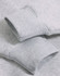 Close-up of a light grey fleece oversized hoodie featuring ribbed cuffs and a soft texture.