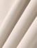 A close-up of soft, beige fabric showcasing the texture of an oversized fleece hoodie. It includes a logo.