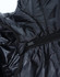 A close-up of a lightweight hooded puffer jacket in black, showcasing its zipper and inner lining.
