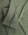 A green cotton blend long-sleeve shirt featuring buttoned cuffs and a logo.
